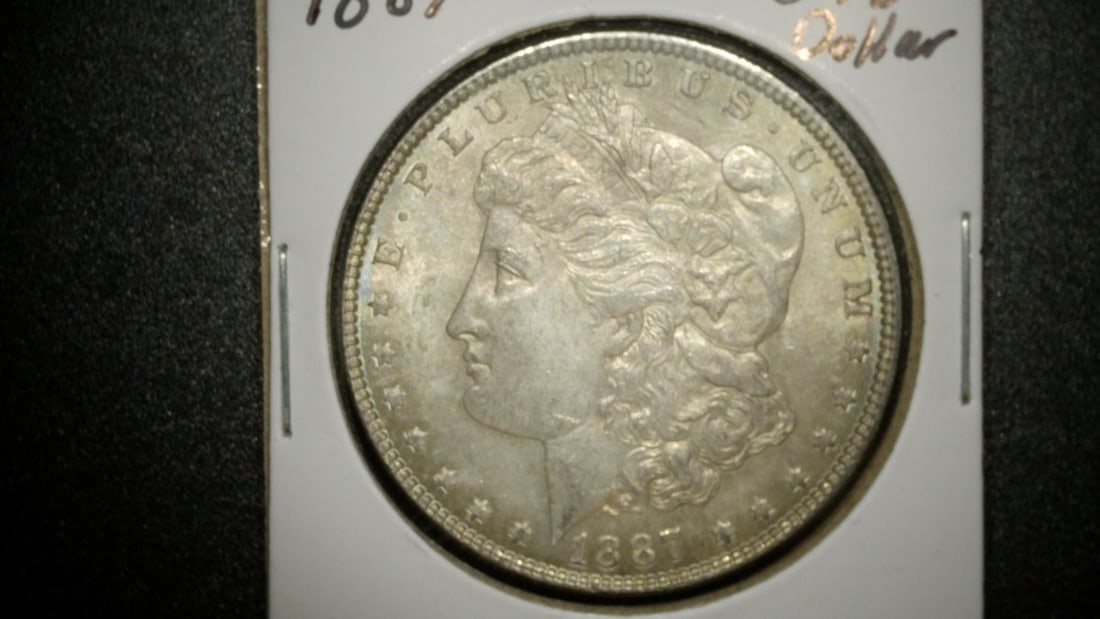 1887-P Morgan Silver Dollar Mint State by George T. Morgan: **Important** Please read below description on how to avoid high shipping costs. This stunning 1887 Morgan Silver Dollar from the Philadelphia Mint is a remarkable example of a Mint State coin. It