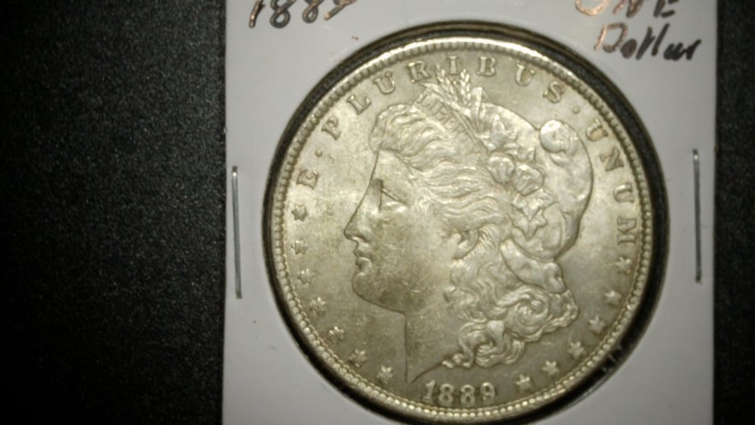 1889-P Morgan Silver Dollar Mint State Coin by George T. Morgan 90% Silver: **Important** Please read below description on how to avoid high shipping costs. This exquisite 1889 Morgan Silver Dollar from the Philadelphia Mint showcases the remarkable artistry of renowned