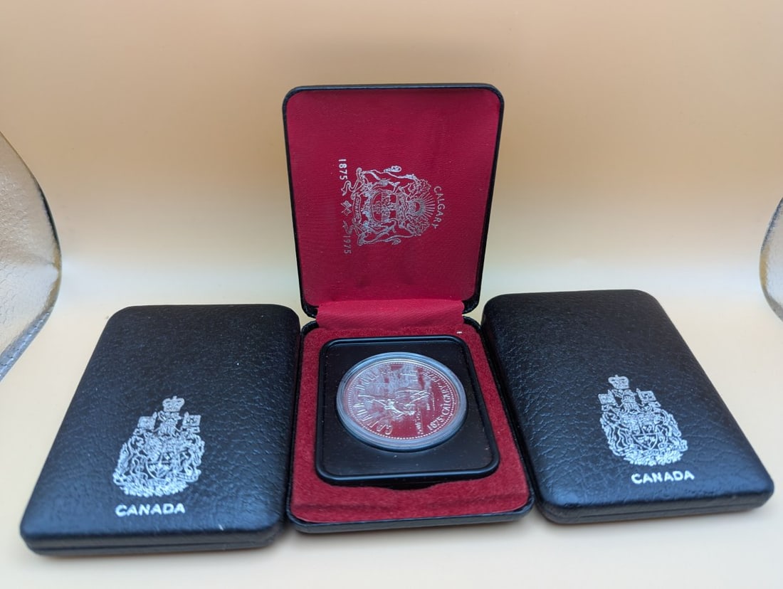 Lot of 3 1975 Royal Canadian Mint Calgary Centennial Proof Silver Dollars: **Important** Please read below description on how to avoid high shipping costs. This is a lot of three 1975 Canada Proof Silver Dollars, each commemorating the Calgary Centennial (1875-1975). Struck