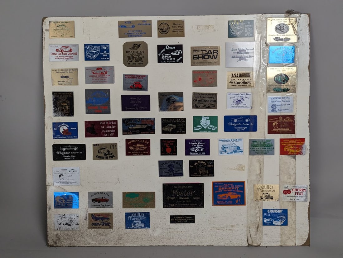 Collection of 1990s Ohio Michigan Car Show Dash Plaques Display Board Automotive Memorabilia: **Important** Please read below description on how to avoid high shipping costs. This remarkable collection features dozens of Ohio and Michigan car show dash plaques mounted on a 32 x 28 inch
