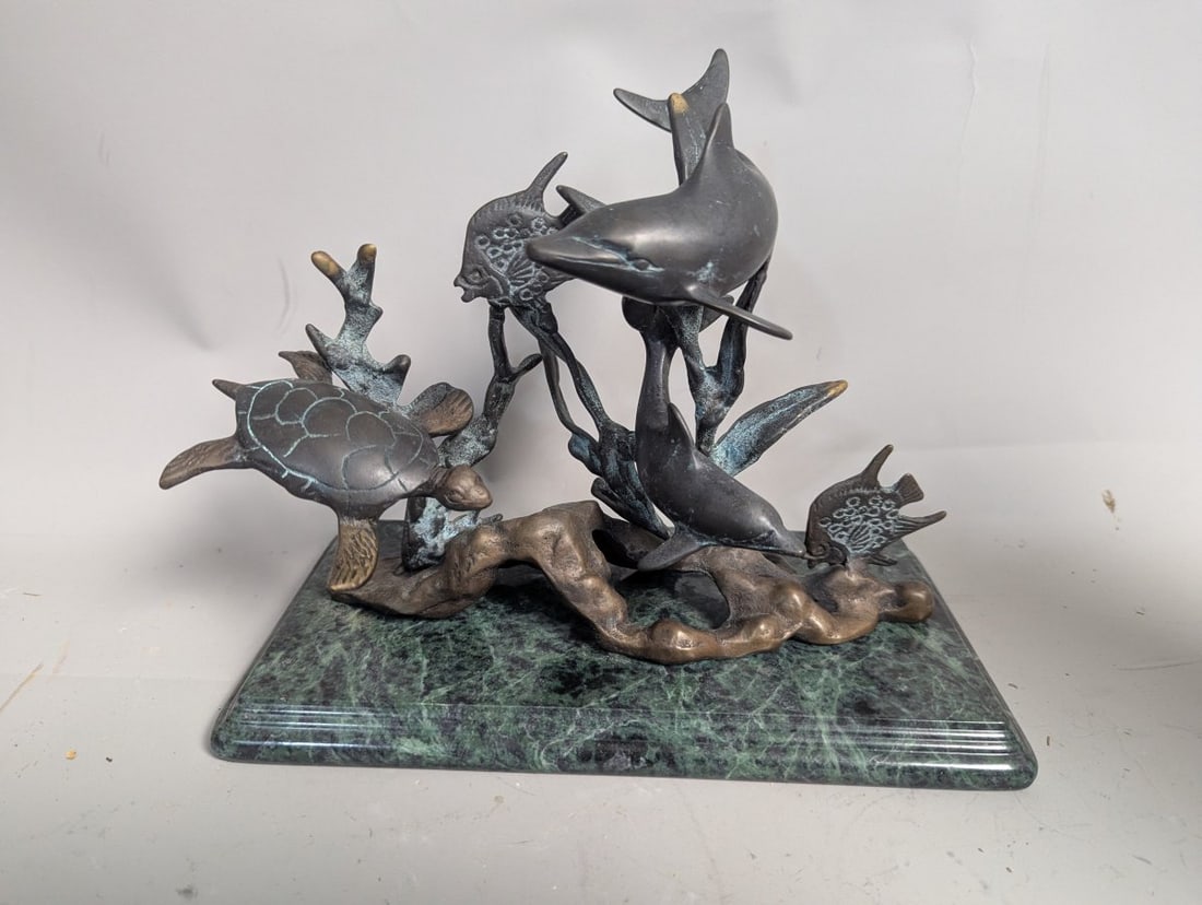 Bronze Marine Life Sculpture Featuring Dolphins and Sea Turtle on Marble Base: **Important** Please read below description on how to avoid high shipping costs. This stunning bronze marine life sculpture measures 8 high x 10 x 5 1/2 and captures a dynamic scene with two dolphins