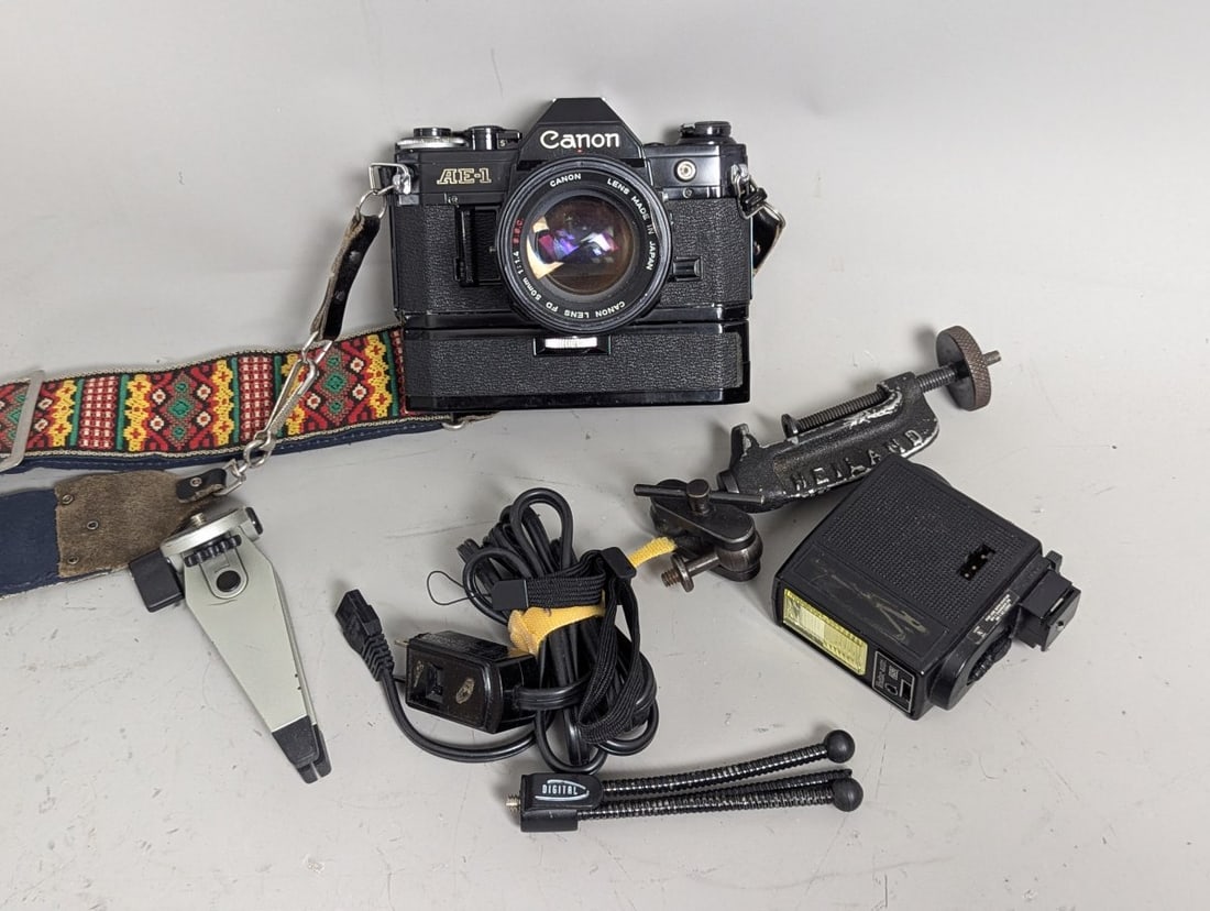 Canon AE-1 35mm SLR Film Camera Bundle with 50mm 1.4 Lens Power Winder Accessories: **Important** Please read below description on how to avoid high shipping costs. Up for auction is a vintage Canon AE-1 35mm SLR film camera bundle featuring the sought-after Canon AE-1 body with seri