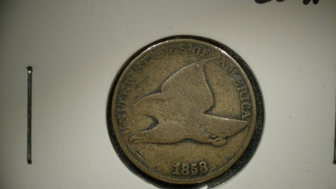 1858 Flying Eagle Cent V.G. Grade by James B. Longacre - Rare US Coin: **Important** Please read below description on how to avoid high shipping costs. This is an 1858 Flying Eagle One Cent coin with a numismatic grade of V.G. (Very Good). Designed by James B. Longacre, 