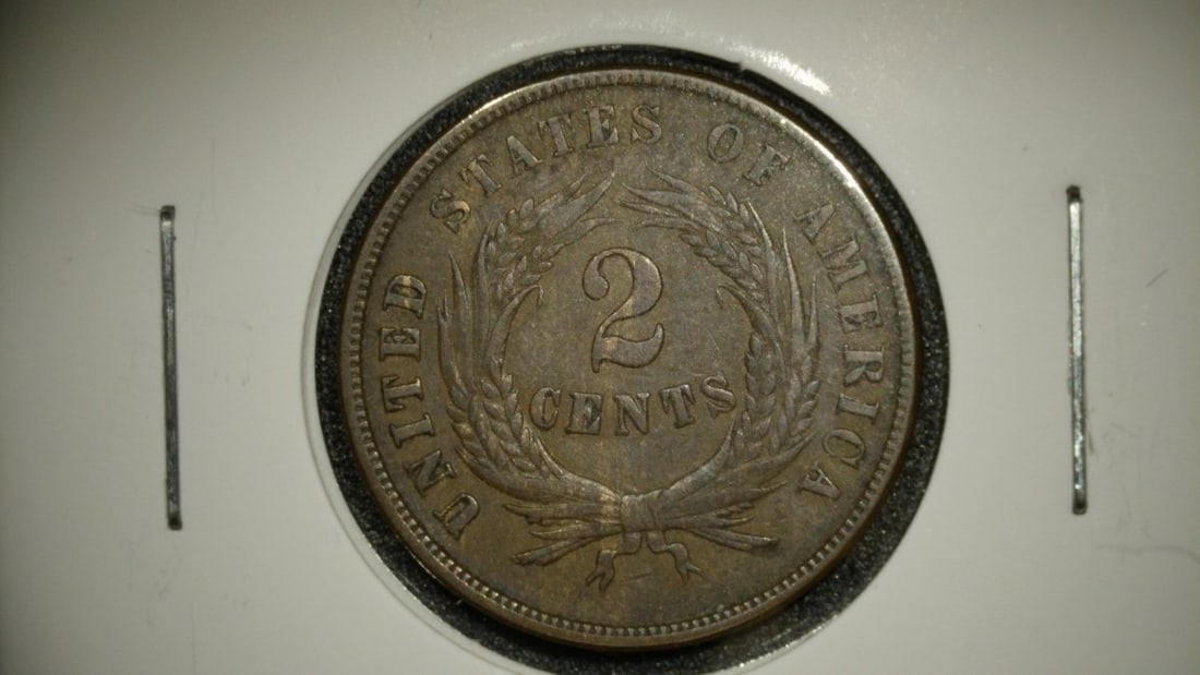 1864 Two Cent Piece VF by James B. Longacre - Large Motto - US Mint Coin: **Important** Please read below description on how to avoid high shipping costs. Up for auction is an 1864 Two Cent Piece, graded Very Fine (VF). This remarkable coin is significant as it marks the fi