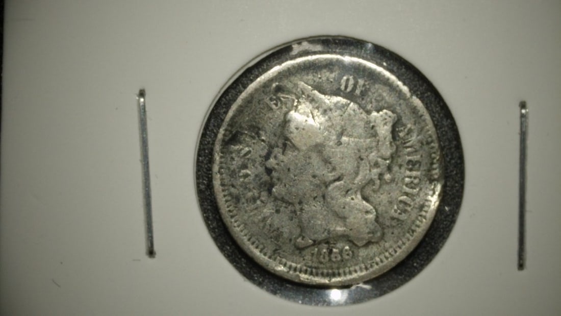 1866 Nickel Three-Cent Piece by James B. Longacre Good (G) Coin: **Important** Please read below description on how to avoid high shipping costs. This is an 1866 Nickel Three-Cent Piece with a grade of Good (G). The coin exhibits heavy circulation wear, but the