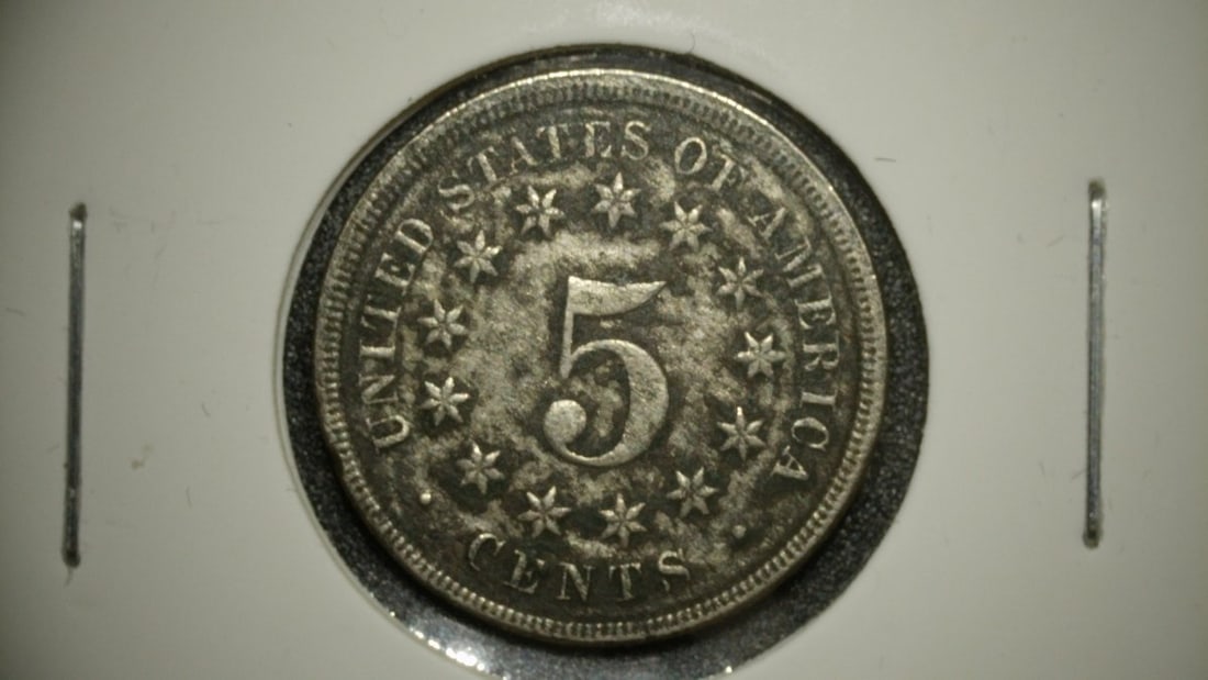 1868 Shield Nickel Five Cent Piece VF by James B. Longacre: **Important** Please read below description on how to avoid high shipping costs. This is an 1868 Shield Nickel Five Cent Piece with a grade of Very Fine (VF). The obverse features a shield design