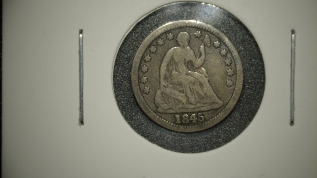1845 Seated Liberty Half Dime V.G. by Christian Gobrecht - 90% Silver Coin: **Important** Please read below description on how to avoid high shipping costs. This is an 1845 Seated Liberty Half Dime, designed by Christian Gobrecht and minted in Philadelphia (no mint mark). The