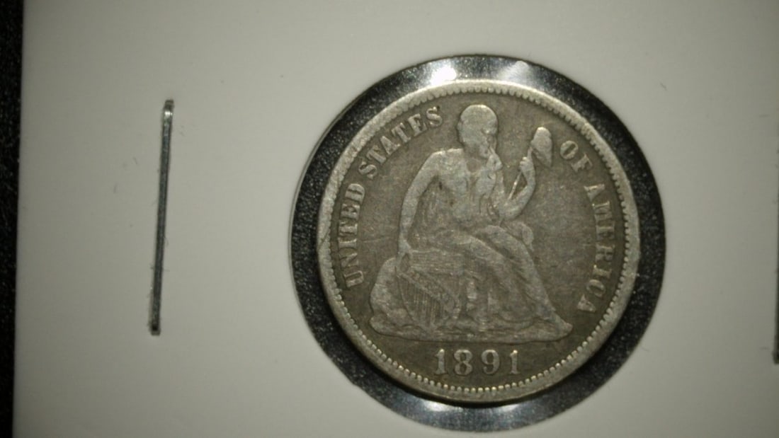 1891-O Seated Liberty Dime by Christian Gobrecht - Very Fine (VF) Silver Coin: **Important** Please read below description on how to avoid high shipping costs. Up for auction is a 1891-O Seated Liberty Dime, a stunning representation of U.S. numismatic history. This coin,