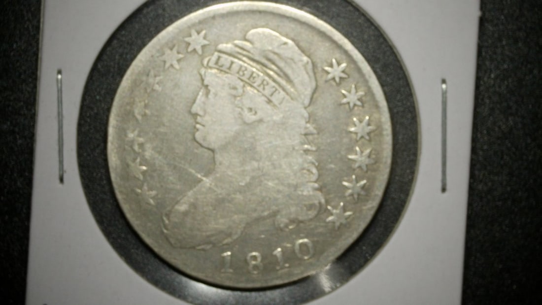 1810 Capped Bust Half Dollar by John Reich - Very Good Condition Coin: **Important** Please read below description on how to avoid high shipping costs. This is an 1810 Capped Bust Half Dollar, a classic piece of early American silver coinage designed by John Reich. The