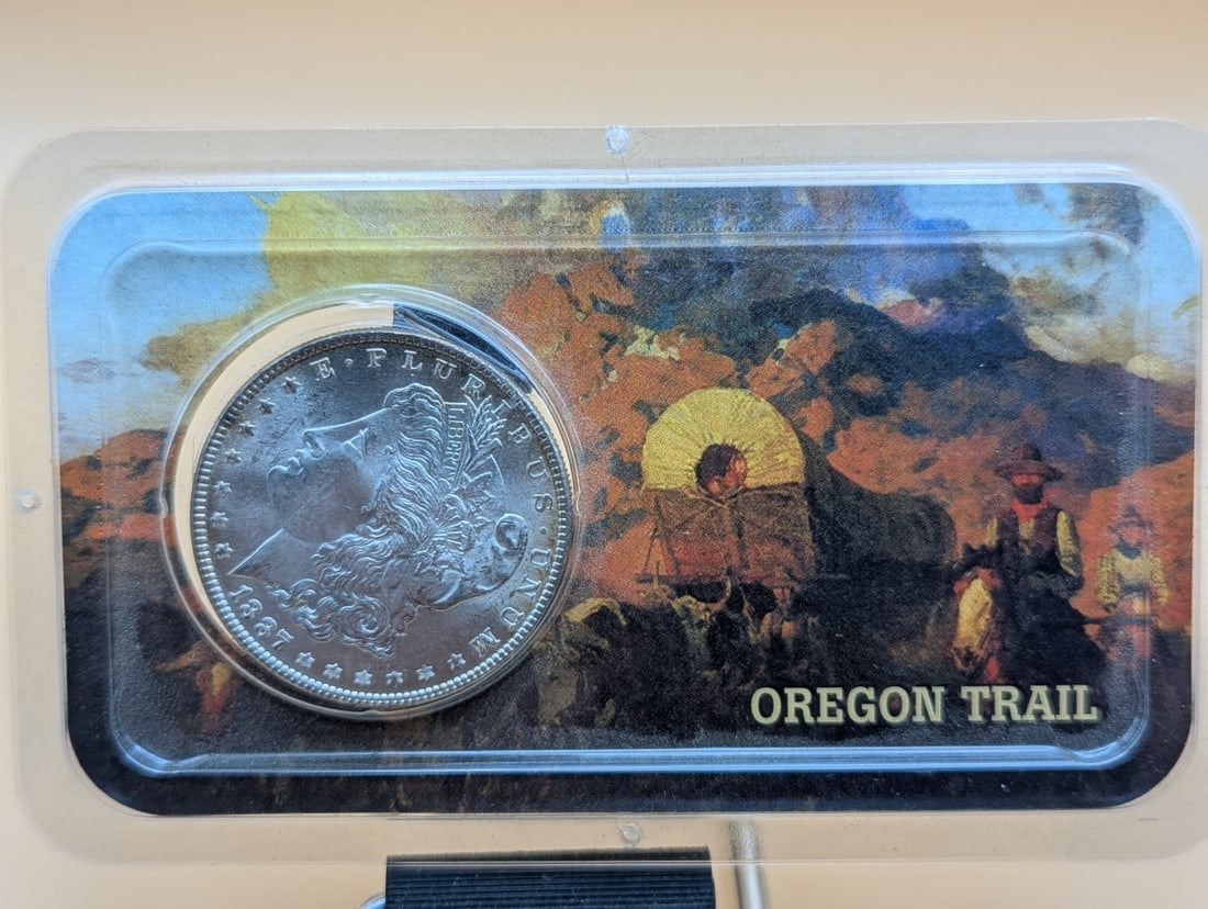 1887-P US Morgan Silver Dollar by George T. Morgan Mint State Uncirculated: **Important** Please read below description on how to avoid high shipping costs. This stunning 1887-P Morgan Silver Dollar, designed by George T. Morgan, showcases exquisite details and a brilliant
