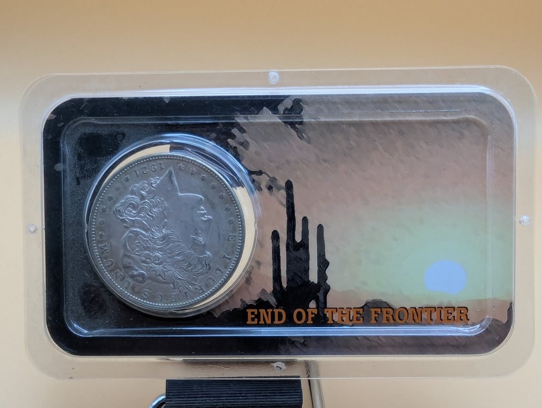 1921-S Morgan Silver Dollar XF by George T. Morgan in Littleton Tribute to the Wild West: **Important** Please read below description on how to avoid high shipping costs. Explore this exceptional 1921-S Morgan Silver Dollar, graded Extremely Fine (XF). This iconic coin, designed by