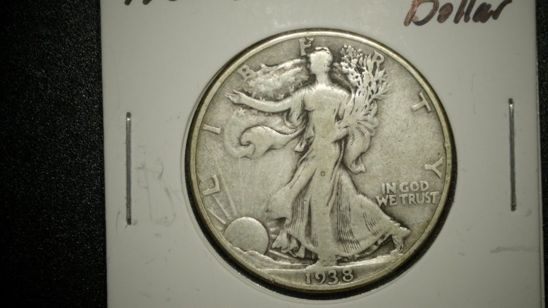 1938-D Walking Liberty Half Dollar by Adolph A. Weinman - Very Good Condition: **Important** Please read below description on how to avoid high shipping costs. This 1938-D Walking Liberty Half Dollar is a beautiful representation of numismatic artistry, designed by Adolph A.
