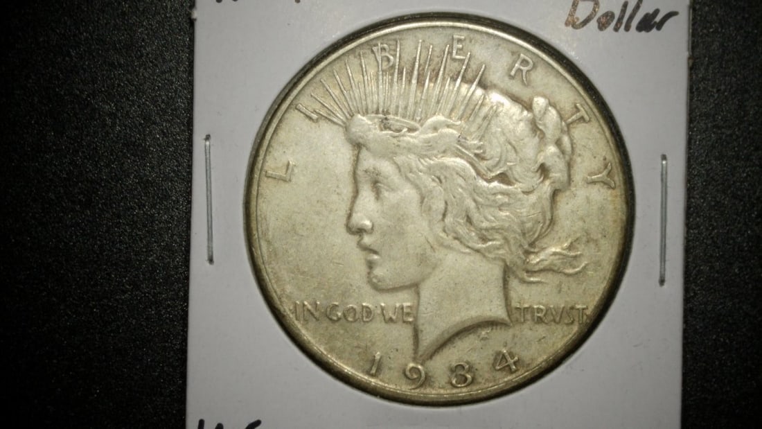 1934-D Silver Peace Dollar by Anthony de Francisci - Very Good Condition Coin: **Important** Please read below description on how to avoid high shipping costs. This listing features a 1934-D Silver Peace Dollar, a remarkable coin designed by Anthony de Francisci. Graded in Very