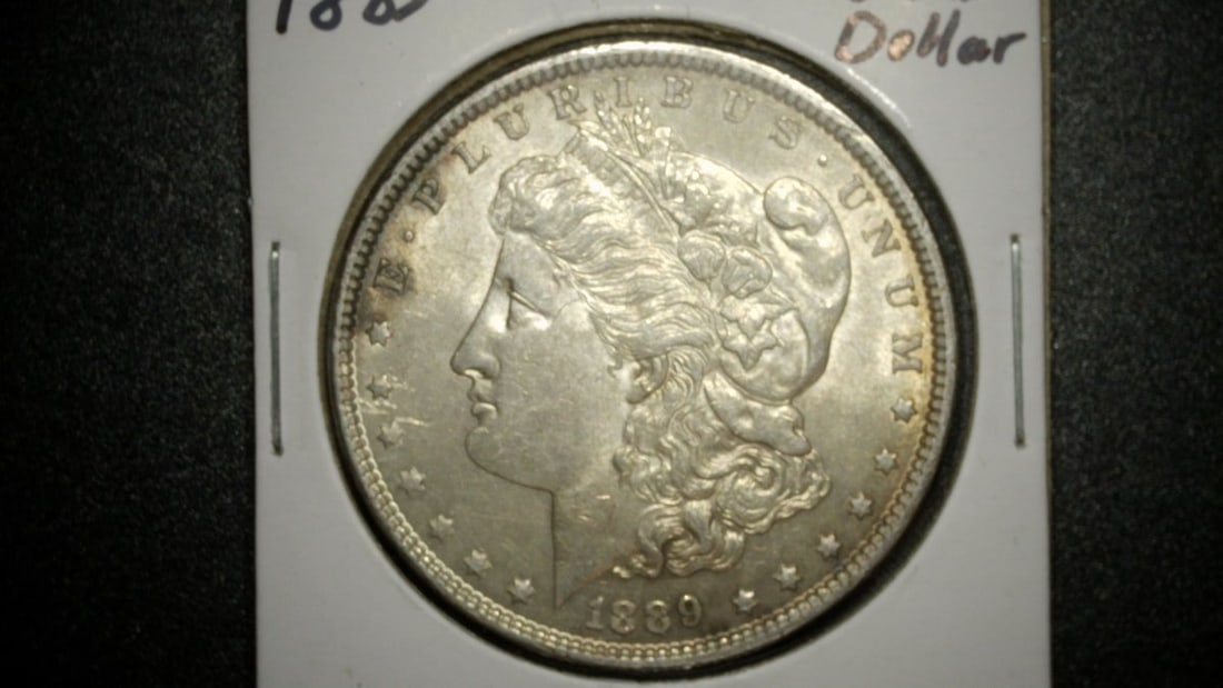 1889-P Morgan Silver Dollar by George T. Morgan Uncirculated Coin: **Important** Please read below description on how to avoid high shipping costs. Up for auction is an 1889-P Morgan Silver Dollar, expertly crafted by engraver George T. Morgan. This exquisite coin