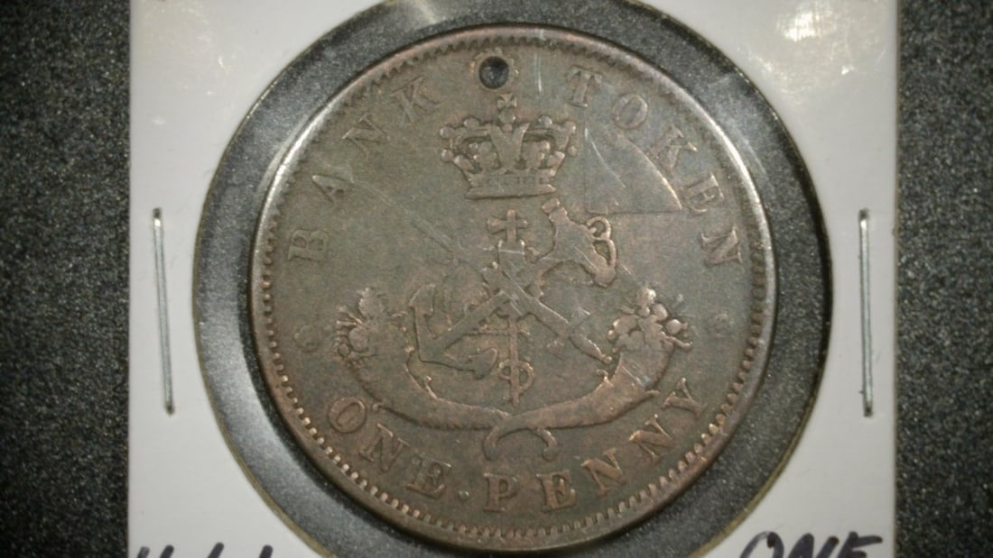 1852 Bank of Upper Canada One Penny Token - Holed - Very Good - Historical Currency: **Important** Please read below description on how to avoid high shipping costs. This is a one penny bank token issued by the Bank of Upper Canada in 1852. The obverse features the arms of Upper