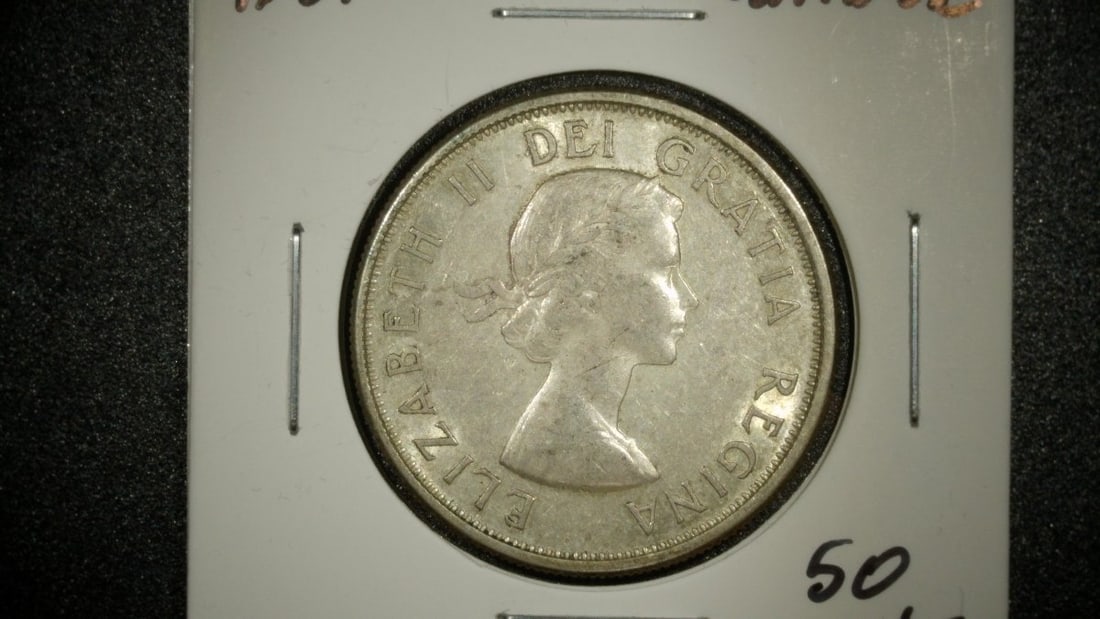 1961 Canada 50 Cents Silver Coin Uncirculated Queen Elizabeth II Royal Canadian Mint: **Important** Please read below description on how to avoid high shipping costs. This is a 1961 Canadian 50 cent coin featuring the laureate portrait of Queen Elizabeth II on the obverse and the Canad