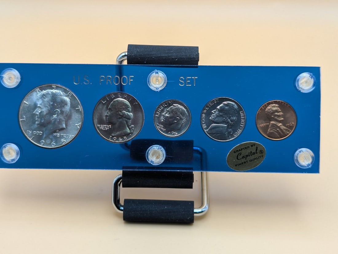 1965 US Mint Proof Set Capital Holder Excellent Condition Display Collectible Coins: **Important** Please read below description on how to avoid high shipping costs. Presenting the stunning 1965 U.S. Mint Proof Set housed in a vintage blue Capital Plastics holder. This exquisite set i