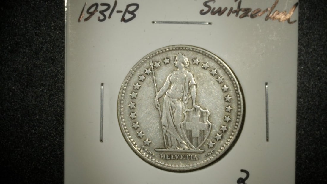 1931-B Switzerland 2 Francs Silver Coin XF Antoine Bovy Design: **Important** Please read below description on how to avoid high shipping costs. This beautiful 1931-B Switzerland 2 Francs Silver Coin is graded Extra Fine (XF), showcasing the classic 'Standing Helv