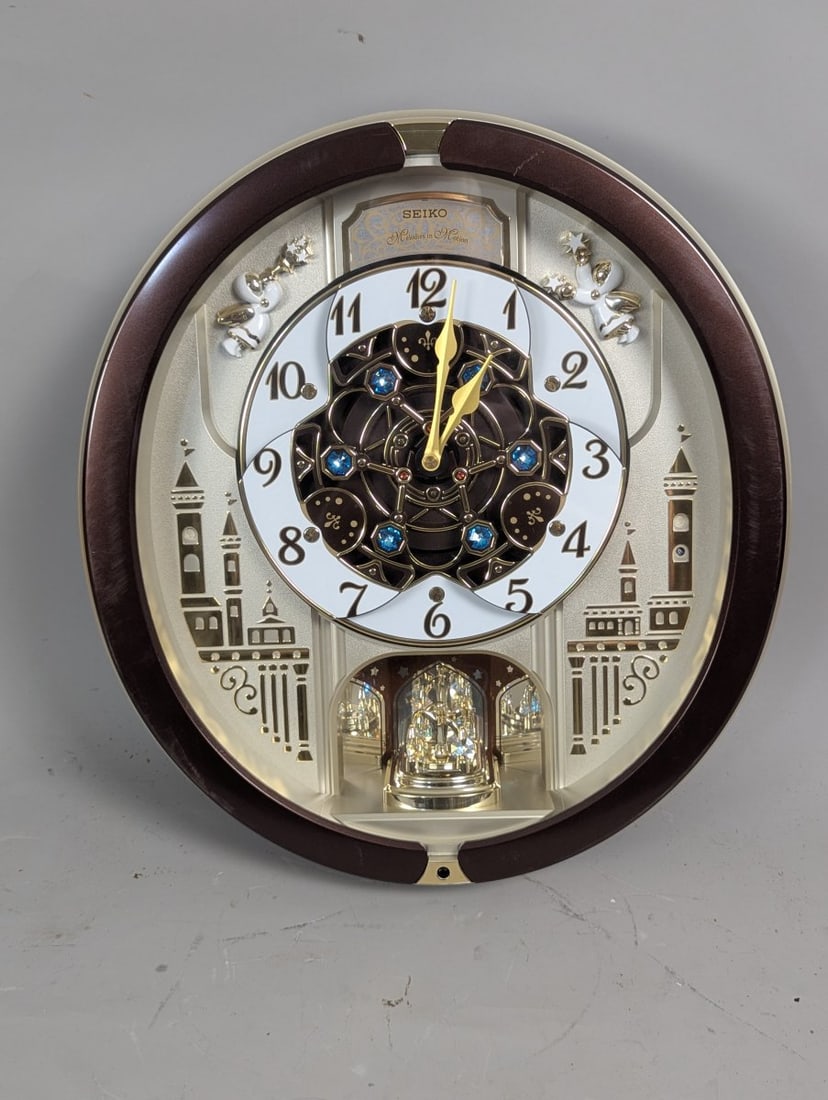 Seiko Melodies in Motion Musical Wall Clock QXM491B with Swarovski Crystals: **Important** Please read below description on how to avoid high shipping costs. Up for auction is a stunning Seiko Melodies in Motion Musical Wall Clock, Model QXM491B. This exquisite piece measures 