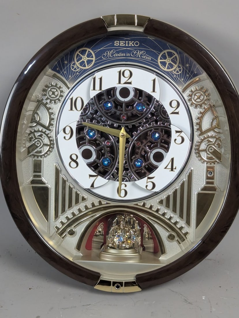 Seiko Melodies in Motion Wall Clock QXM386BRH Musical Animated Decor: **Important** Please read below description on how to avoid high shipping costs. Up for auction is a stunning Seiko Melodies in Motion Wall Clock, Model QXM386BRH, measuring 18 x 16 x 4 inches. This e
