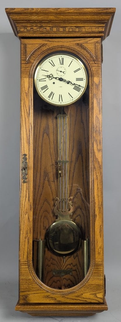 Howard Miller The Commodore Wall Clock Model 612-485 Oak Design with Pendulum & Weight: **Important** Please read below description on how to avoid high shipping costs. This stunning Howard Miller 'The Commodore' wall clock stands at an impressive 52 inches high, 19 inches wide, and 9