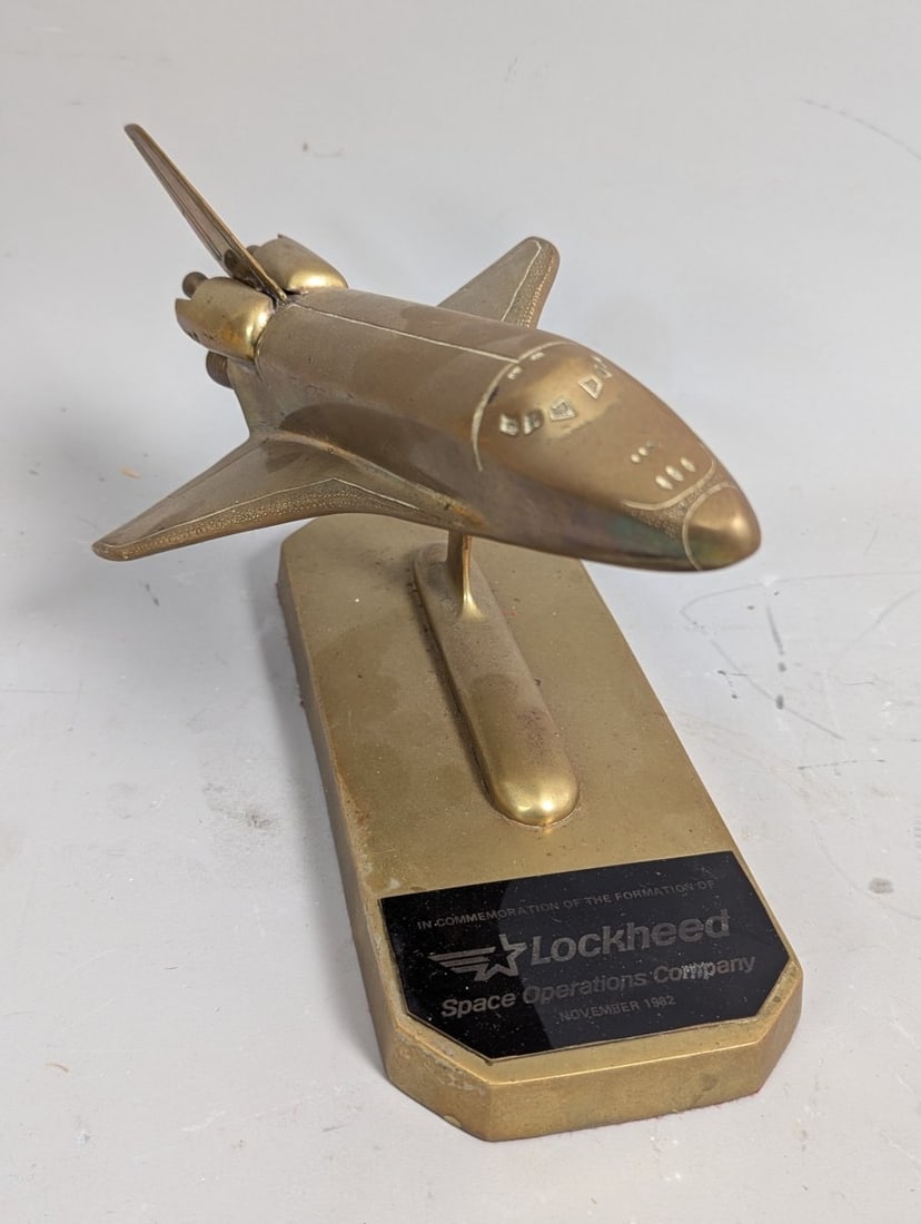 Lockheed Space Operations Company Brass Space Shuttle Model Commemorative Desk Decor: **Important** Please read below description on how to avoid high shipping costs. Offered here is a remarkable 7 high x 9 1/2 x 6. brass model commemorating the formation of the Lockheed Space Operatio