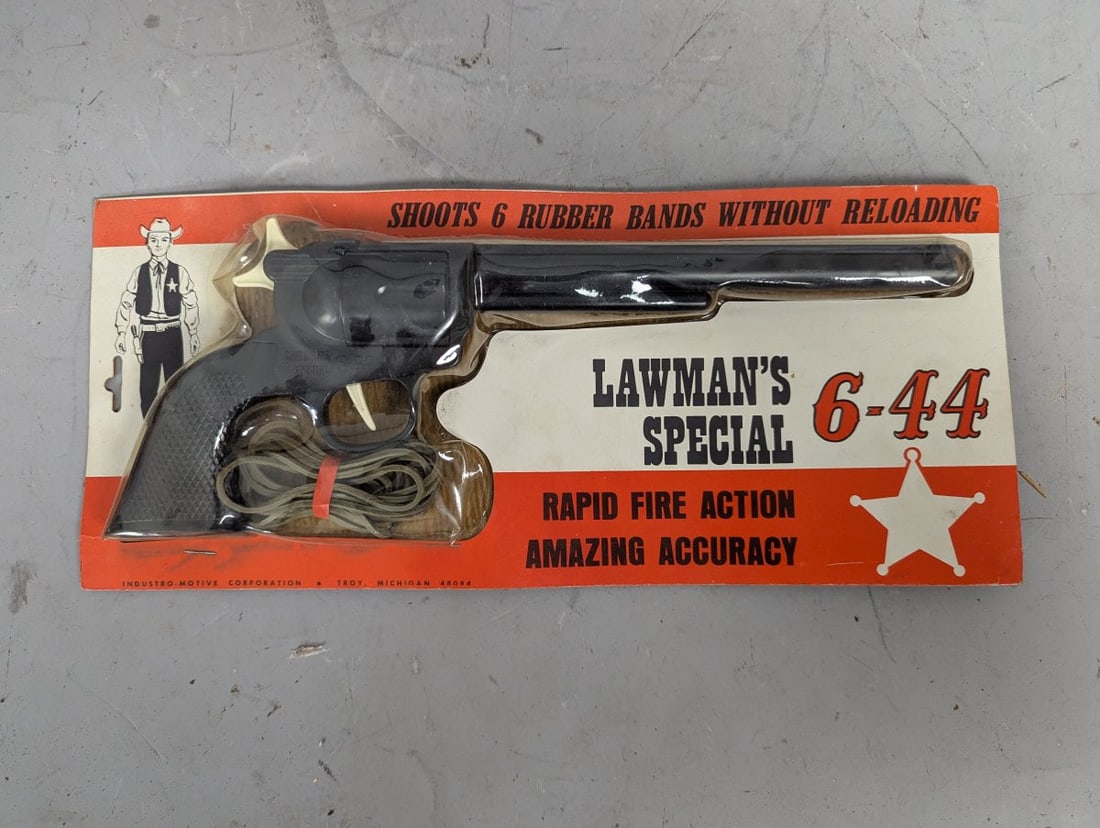 Industro-Motive Lawman's Special 6-44 Rubber Band Gun Vintage Western Toy: **Important** Please read below description on how to avoid high shipping costs. Up for auction is a rare Industro-Motive Lawman's Special 6-44 Rubber Band Gun, measuring 14 x 6 x 2 inches. This New O