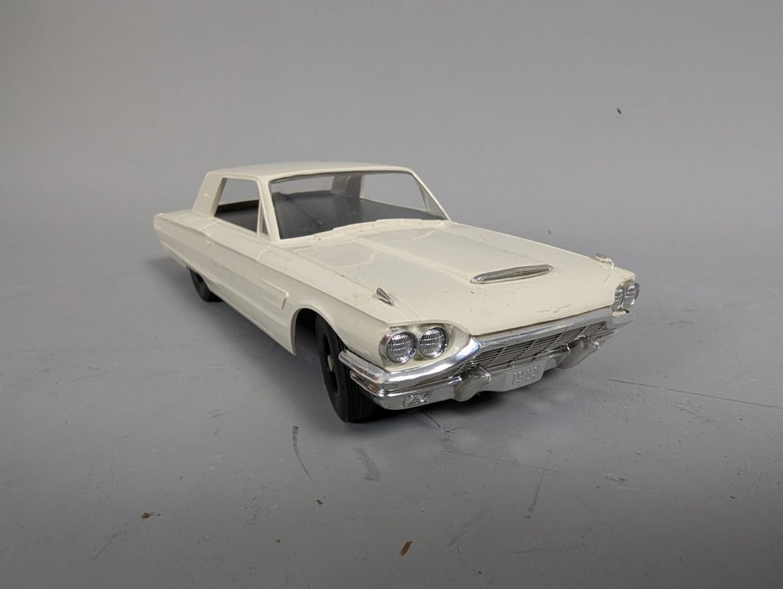 Vintage Strombecker 1964 AMT Turnpike Ford Thunderbird Slot Car with Rare Articulating Guide Ring: **Important** Please read below description on how to avoid high shipping costs. This vintage AMT Turnpike1964 Ford Thunderbird slot car measures 8 x 3 x 2 1/4 inches. Not tested. It features a rare
