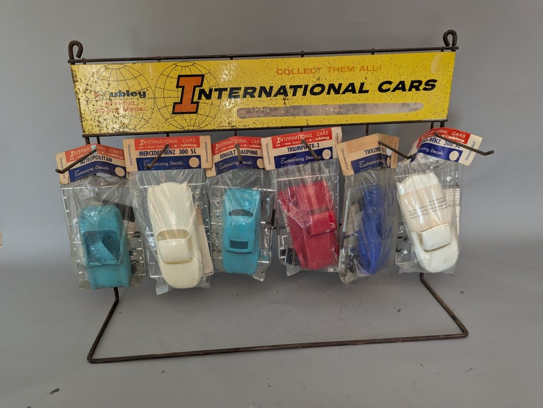 Vintage Hubley International Cars Model Kits Store Display Rack with 6 New Old Stock Kits: **Important** Please read below description on how to avoid high shipping costs. Experience a piece of automotive history with this vintage store display, measuring 17 high x 25 x 7, showcasing 6 New