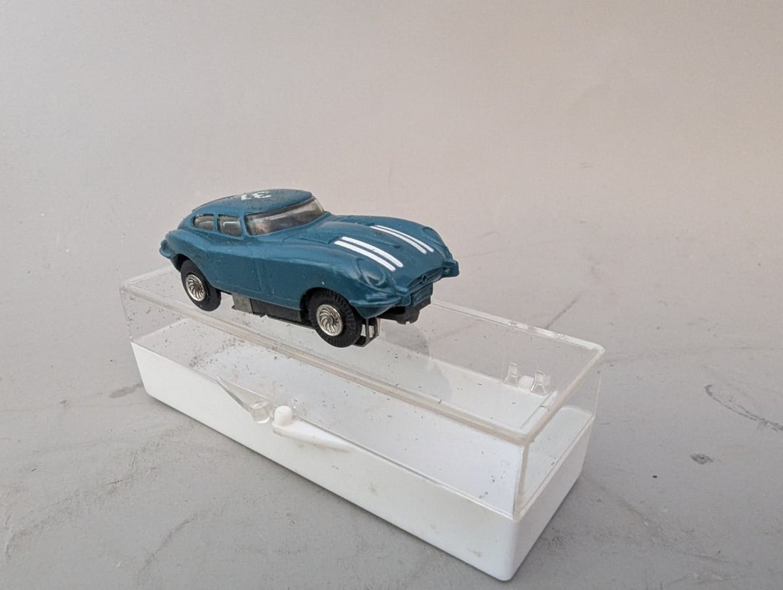 Vintage Marx HO Scale Jaguar XKE Slot Car with Original Plastic Case Collectible Toy: **Important** Please read below description on how to avoid high shipping costs. This is a stunning vintage Marx HO Scale Jaguar XKE Slot Car, a must-have collectible from Louis Marx and Company. The