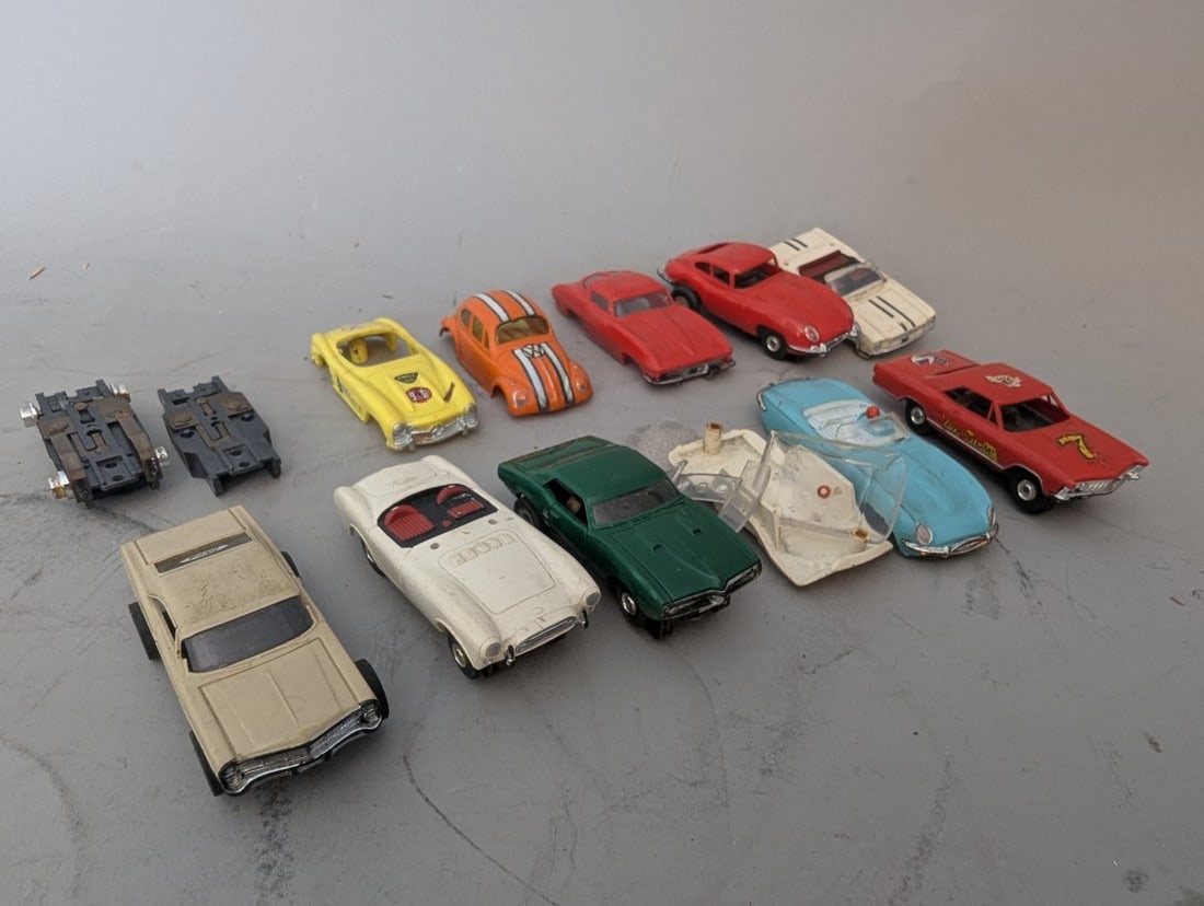 Vintage HO Scale Slot Car Collection with Chassis, Bodies, and Parts for Restoration: **Important** Please read below description on how to avoid high shipping costs. Discover a fantastic lot of HO scale cars, chassis, and bodies, featuring a range of components perfect for hobbyists a