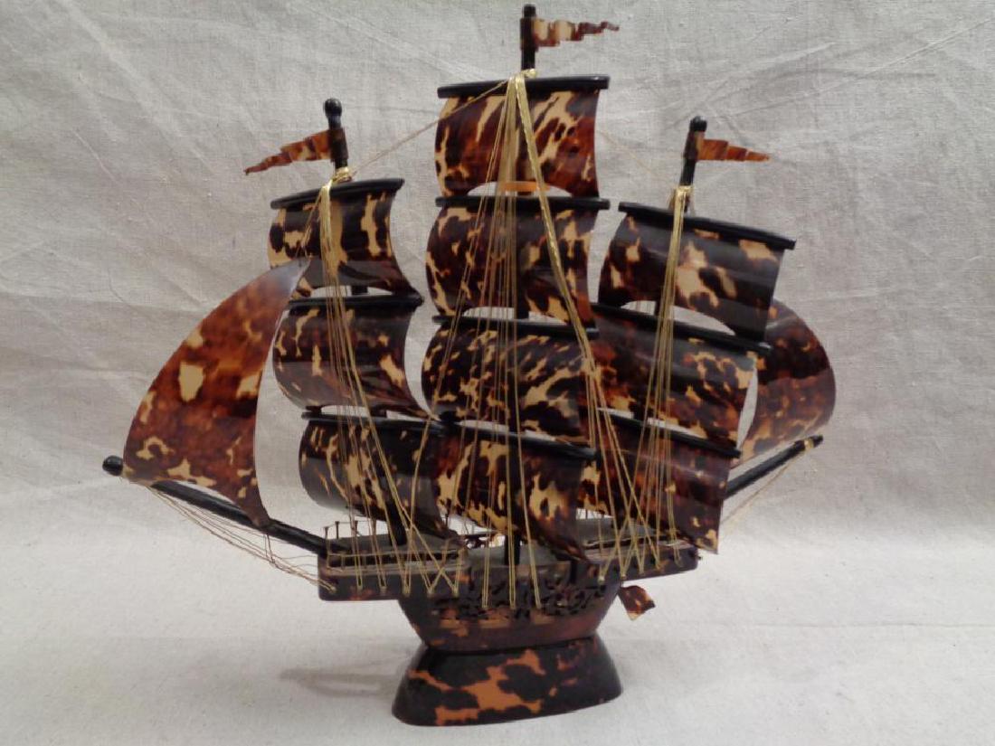 Vintage Tortoise Celluloid Sailing Ship: Three masted sailing ship. Tortoise celluloid overlaid wood . Sails on wood masts. Gold thread riggings and nail railings. Excellent condition. Circa 1930's/ 50's. 14" H x 15" L approx.