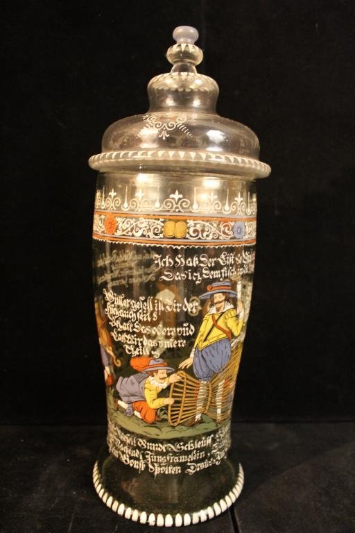Vintage Bohemian Enamel Humpen Pokel Glass Jar: Hand blown green tinted glass jar and clear glass lid. Hand enameled with figures including a jester playing a violin, two men wit a nude woman in a fish trap, a monk, and a bearded man in crutches. I