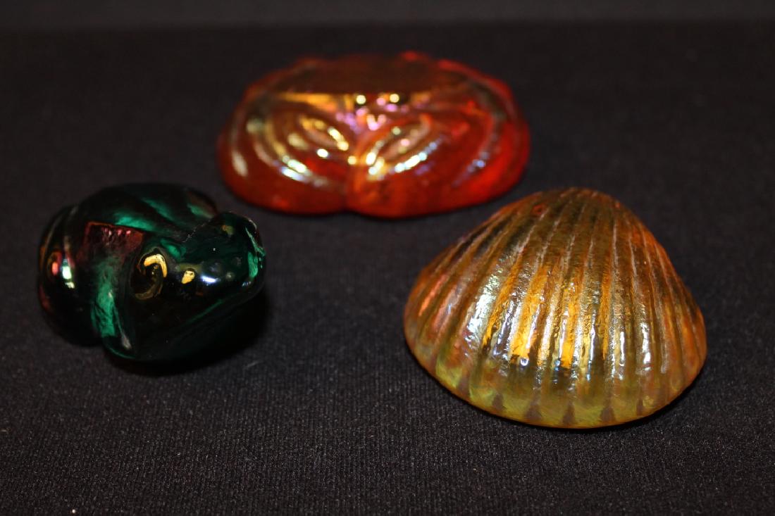 Three Robert Held Studio Art Glass Paperweights: Red tone crab, yellow tone shell, and green tone frog. All with iridescent finishes. Robert Held labels and etched RHAG signatures. All excellent condition.