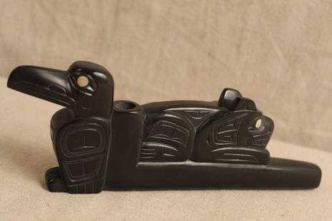 Glen Pollard (Haida b.1957) Carved Argillite Pipe: Hand carved argillite with inlaid eyes to raven and crouched animal. Signature to bottom. Excellent like new condition. 9.5" L x 3.25" H approx.
