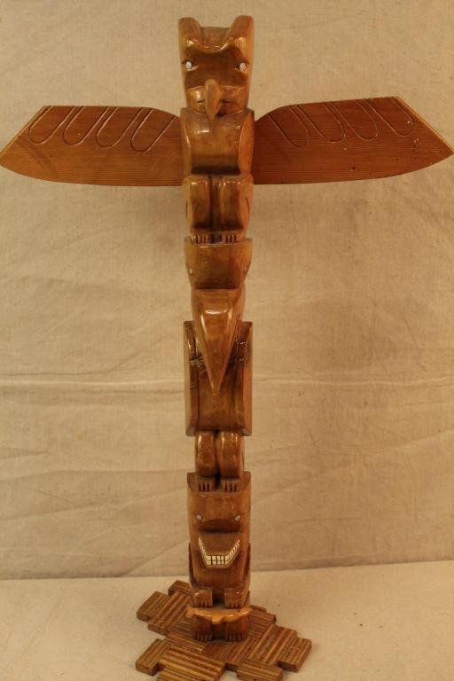 Vintage Hand Carved Nortwest Style Totem Pole: Hand carved cedar with painred details and shellac finish. Plywood "mosaic" base. Signature to back; possibly Lenny or Lanny Lindahl. Circa 1960's. 30.5" H x 20.5" W.