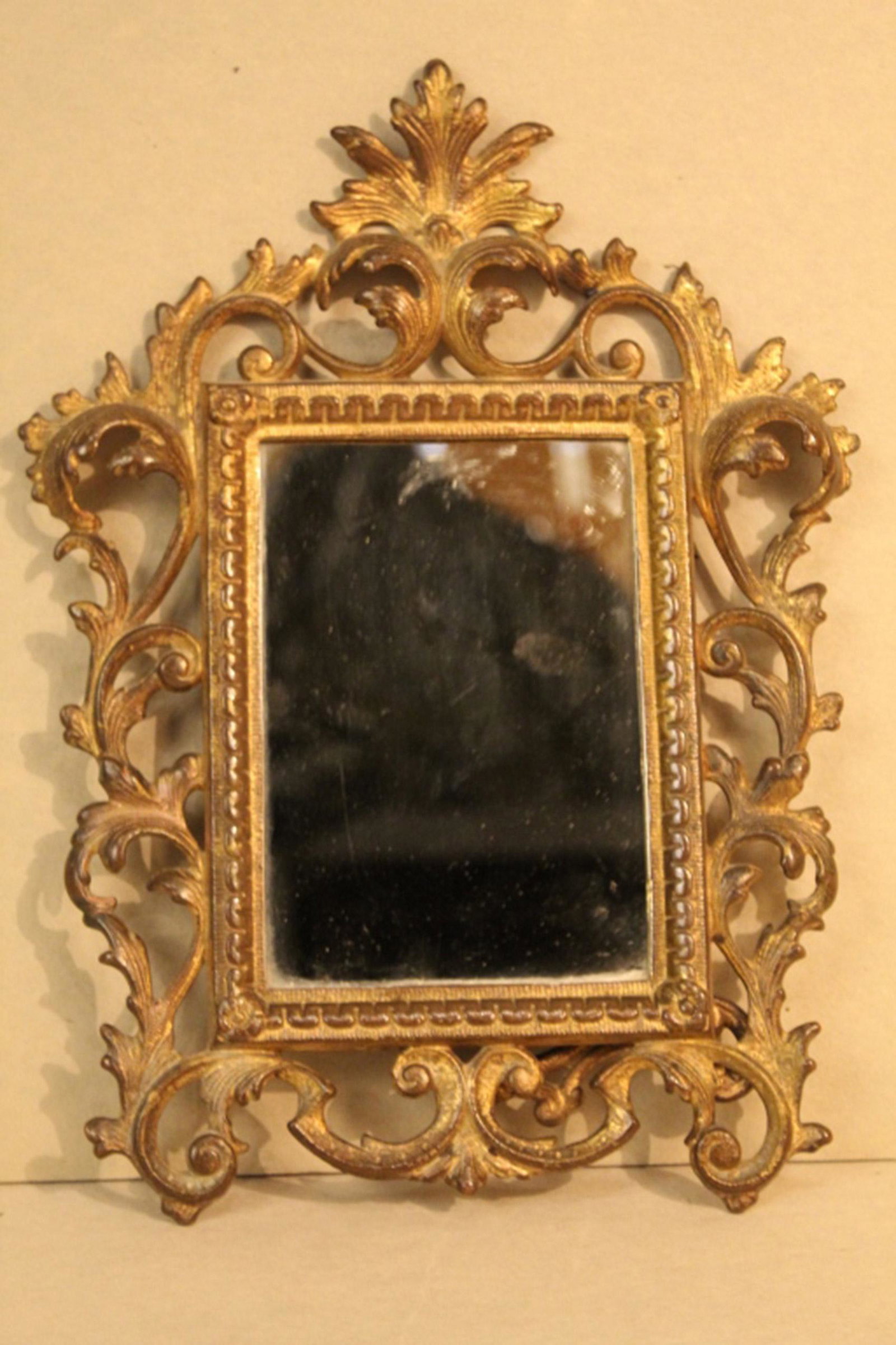 Gilt Metal Late 19th Century Table Mirror: Floral motif gilt table mirror. In excellent vintage condition. Dimensions: 9" x 12".