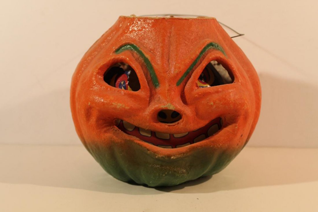 Vintage Jack-O-Lantern: Molded paper pulp with painted finish. Paper liner with some tears, etc. Wire handle. 7\" H x 8\" W x 7\" D approx.