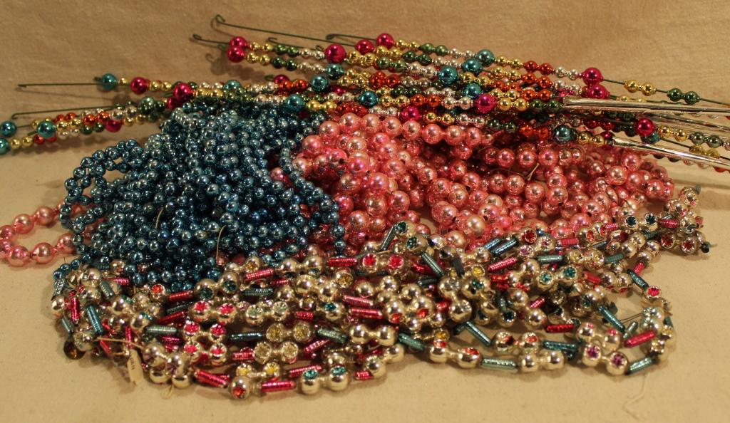 Vintage Mercury Glass Bead Garlands: Four pink bead garlands, 105"approx. Three small blue bead garlands, 94" approx. Two stands of indented double beads, 100" approx. Lot includes wired mercury glass ball floral inserts. Good condition;