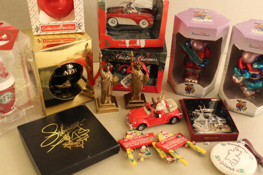 Collection of Christmas Ornaments: Includes 2 Enesco 1990 McDonald's, 2 Santa's Best glass moose, 1993 Radio City Music Hall ball, official Liberace ornament, Nation's Treasures Seattle World's Fair, Maisto Santa VW Bug, and others. 15