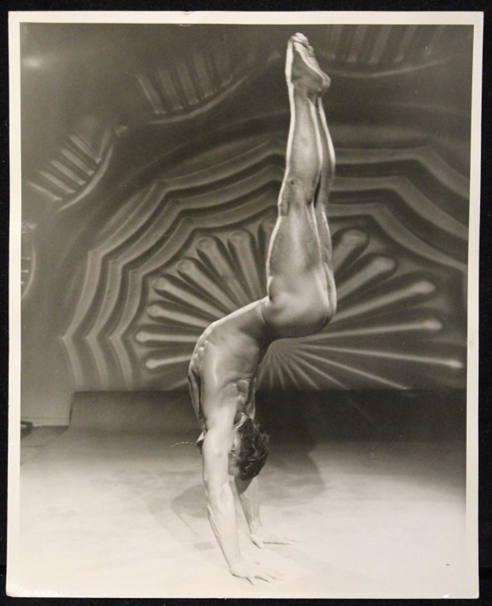 Vintage Bob Mizer AMG Male Nude Photograph: Nude male model doing handstand. "X148 9" in pencil to reverse along with notations in red ink. Sharp image with good tones in excellent condition (minor age creases). 8" x 10" unframed.