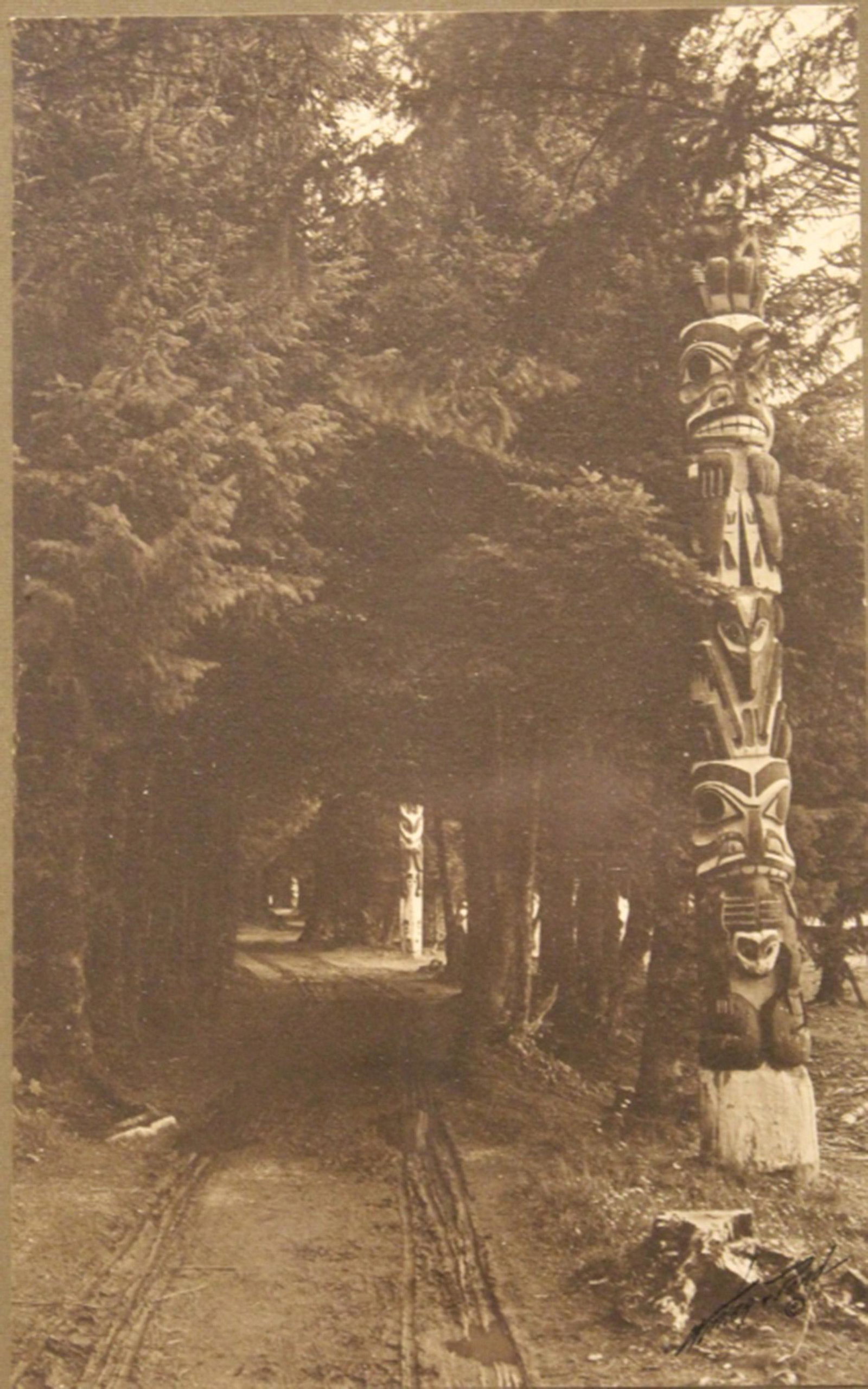 Winter & Pond Signed Totem Poles Photograph: Winter & Pond photograph of Native American totem poles along the Indian River Road, Sitka, Alaska. Photograph in good condition: mounted on mat, in original frame and signed on front;"Seattle Art Co.