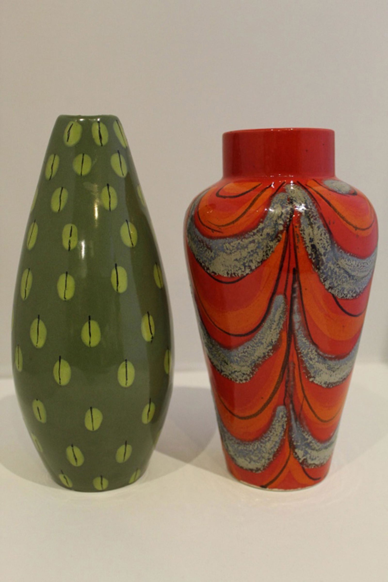 Group of Italian Mid Century Modern Pottery Vases: Mixed lot of two Italian pottery mid century vases: red vase is signed Raymor; green vase possibly by Bitossi. Red vase is in good condition with no chips, cracks or scratches; greens vase has small g