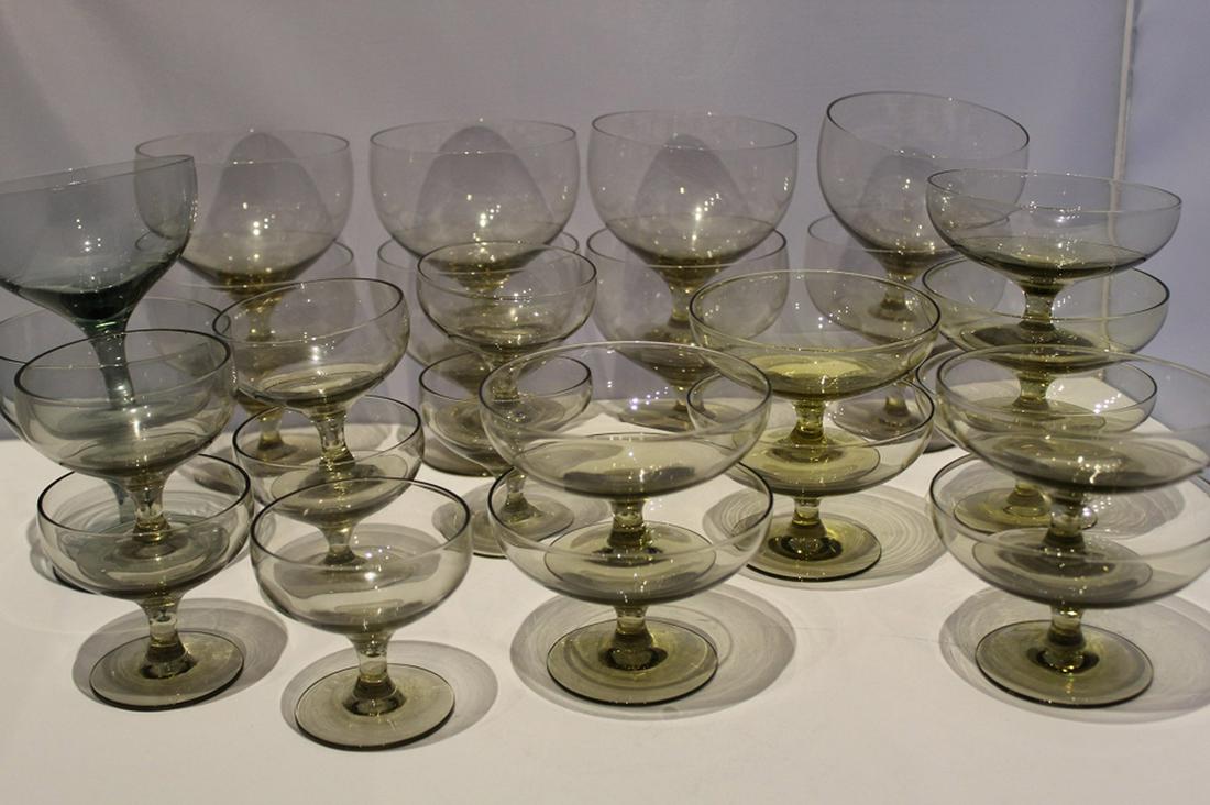 Russel Wright Morgantown American Modern Glass: Includes 10 goblets (4" H x 4" dia.), 9 champagne/ sherbets (2 5/8" H x 4" dia.), and 8 cocktail stems (2 3/4" x 2 7/8" dia.). Various colors; all excellent condition.