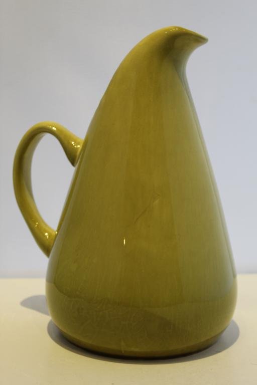 Russel Wright American Modern Chartreuse Pitcher: Good condition with even all-over glaze crazing, small factory glaze flaw at lip, area of darkinging,etc. Impressed mark to base. 10.75" H.