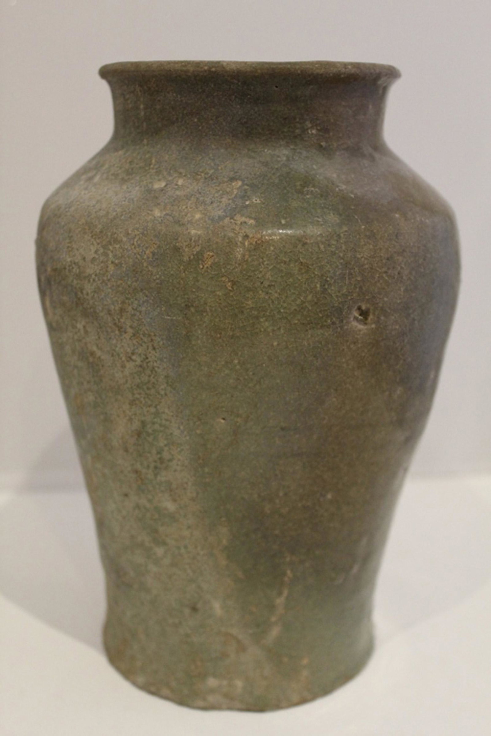 Antique Korean Koryo Celadon Baluster Vase: Antique hand formed Korean Koryo celadon baluster vase. Vase has worn/ distressed surface including missing areas of glaze, overall craquelure and pitting; possibly buried at some point. Dimension 9"H