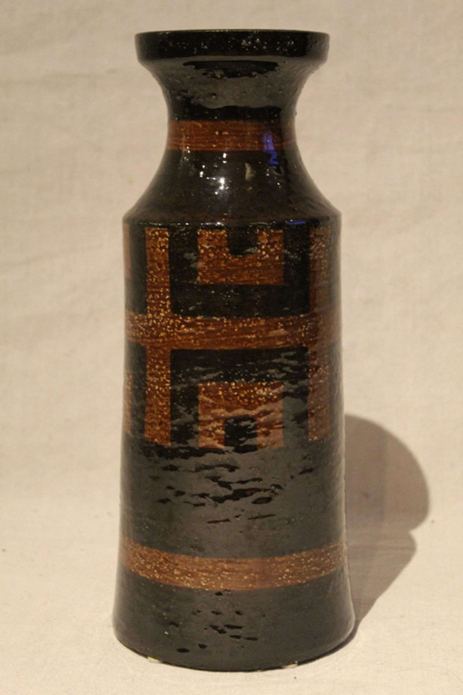 Mid Century Raymor Bitossi Italian Pottery Vase: Possibly Alvino Bagni or Aldo Londi. Gloss brown and black glaze. Label to base "Made in Italy for Eugen Allan's Bazaar". Excellent condition. 11.75" H.