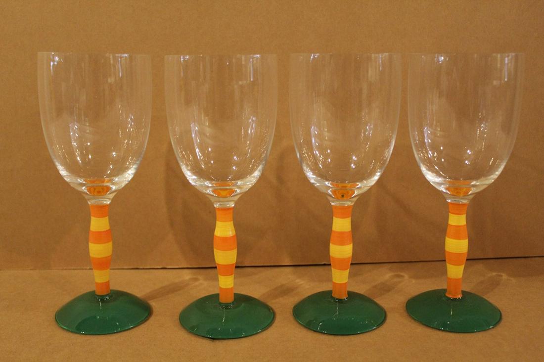 Anne Nilsson Polka Goblets for Orrefors Sweden: Set of 4. Hand enameled orange and yellow stems with green bases. Each signed. Excellent condition (small chip to foot of one). 7.75" H.