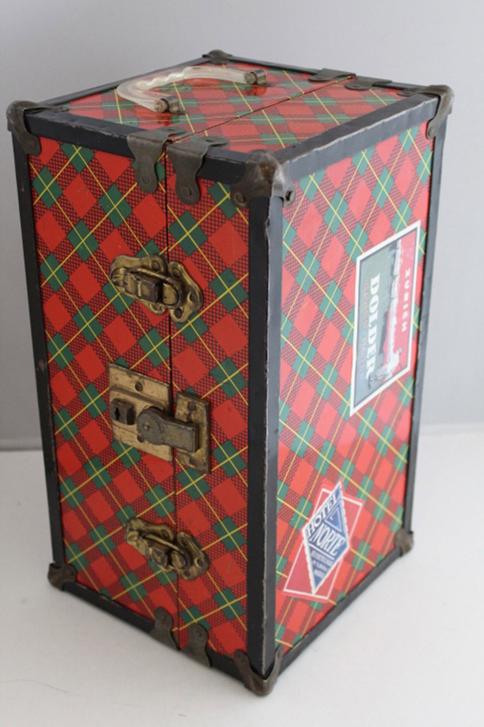 Vintage Miniature Doll Metal Steamer Trunk: Plaid lithographed metal exterior with clear plastic handle and applied old hotel travel labels. Paper lined interior. Work clasps. Very good condition. 14" x 8" x 7.5".