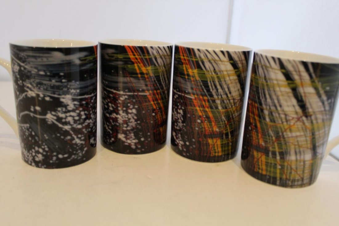 Dale Chihuly Coffee Mugs by W. Derix: Porcelain with printed Chihuly design to exterior. "W. Derix Glasstudios" and "Kunstler Serie 2000 No. 8 Dale Chihuly" to bottoms. Excellent like new unused condition. 4 1/8" H x 2 7/8" dia.